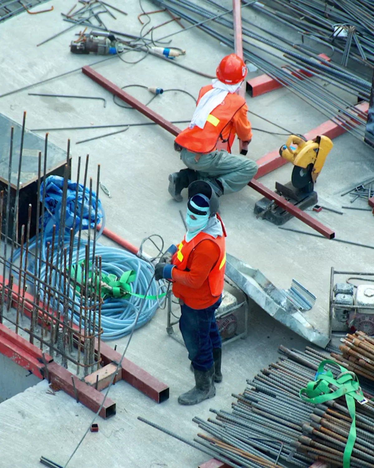 Construction site in San Diego with workers reviewing blueprints